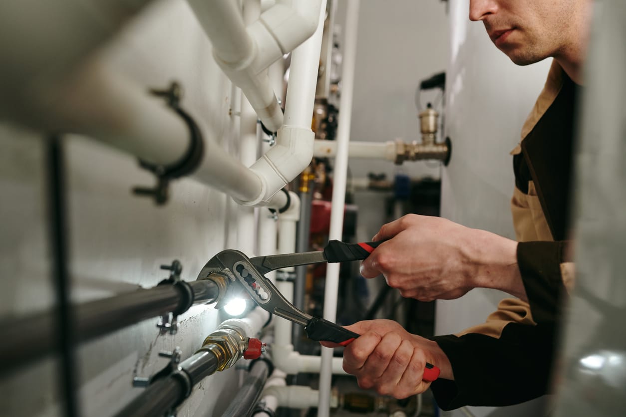 Plumbers maintaining commercial plumbing pipes in Broomfield