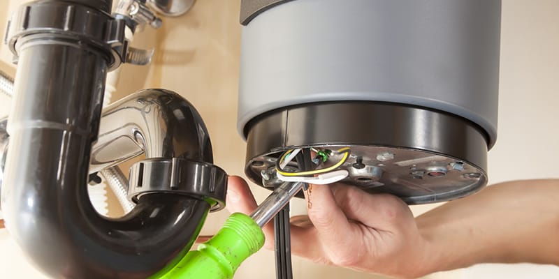 Technician repairing the heating element of a water heater in Broomfield