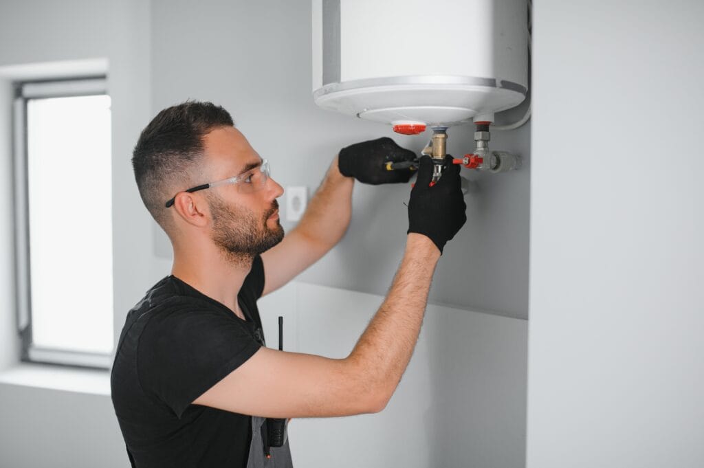Technician performing water heater maintenance in Broomfield